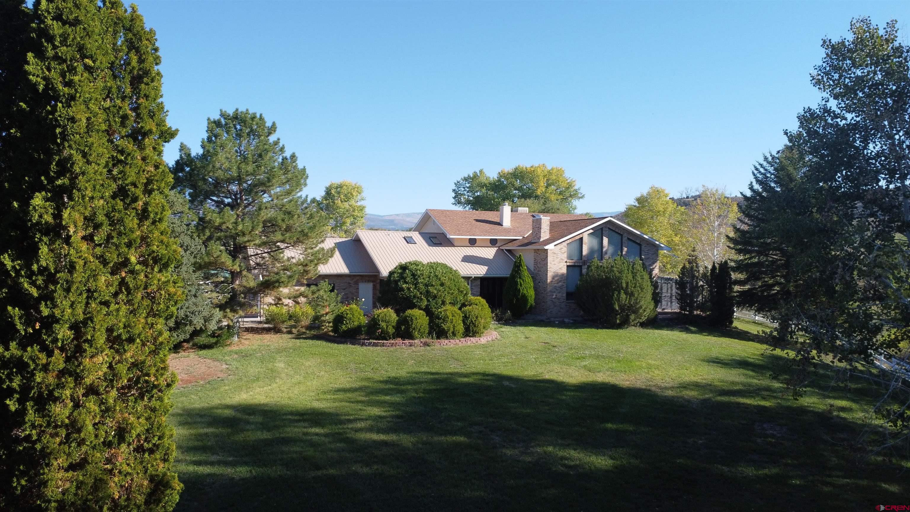 21855 Newland Road Eckert, CO 81418 - Photo 1 of 13 a front view of a house with a yard