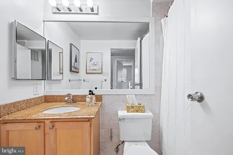 a living room with baby crib furniture and a window
