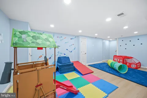 a living room with furniture and a dining table