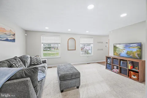 a living room with furniture and a book shelf
