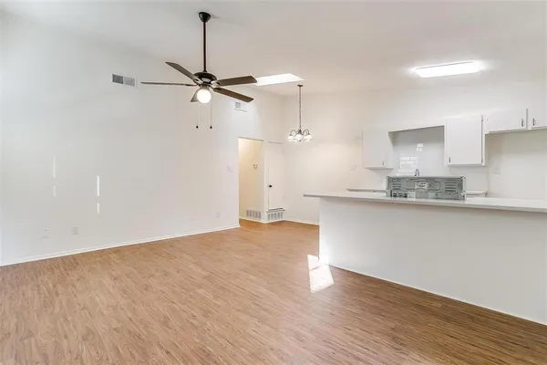 a view of a kitchen with a sink and wooden floor