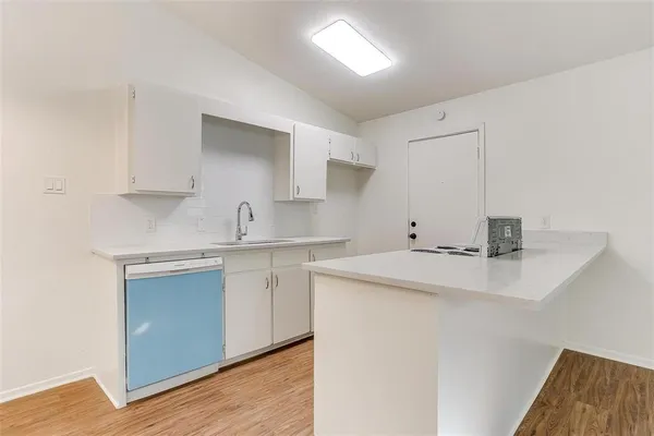 a kitchen with stainless steel appliances a sink and cabinets