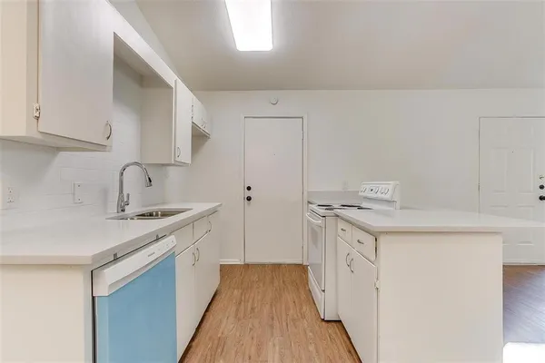 a kitchen with a sink stove and refrigerator