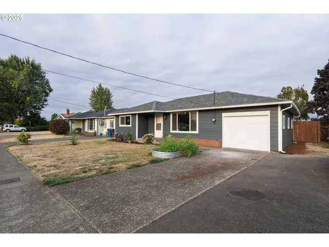 a front view of a house with a yard and a garage