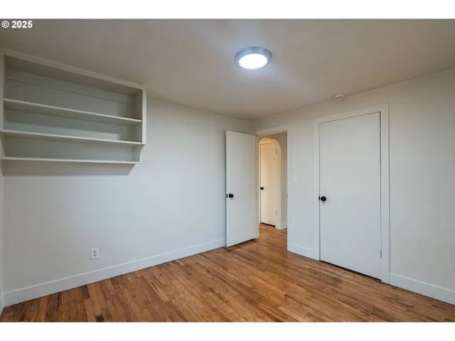 a view of an empty room and wooden floor