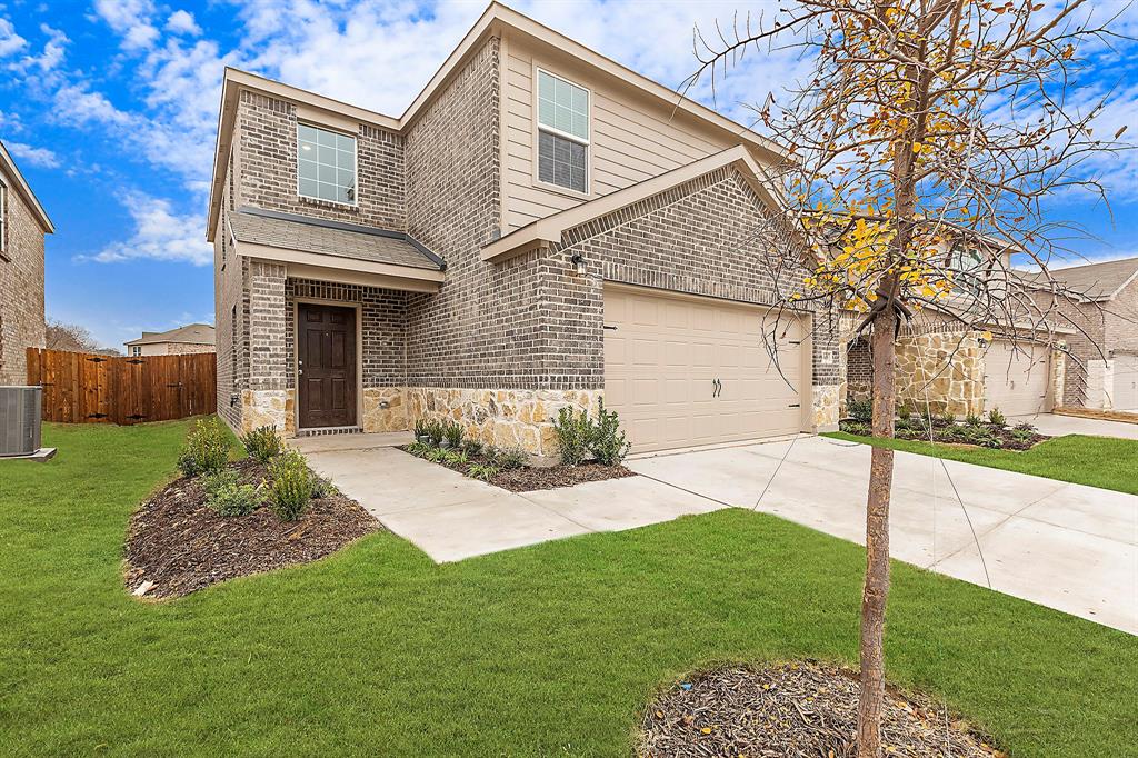 a front view of a house with a garden and yard