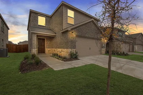 a front view of a house with a yard and outdoor seating