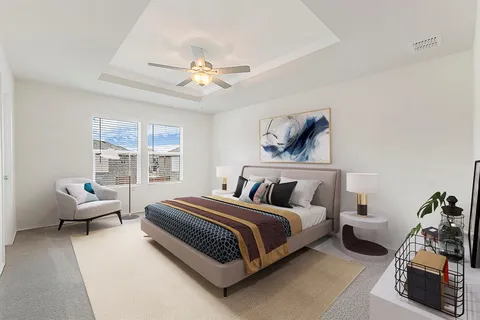 a bedroom with bed and a large window