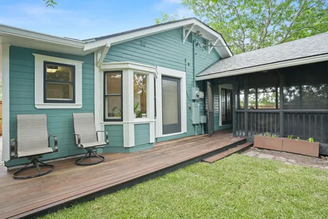 a view of house with backyard and outdoor seating