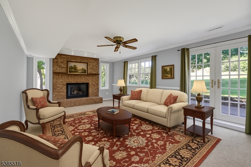 42 Stonewyck Road Chatham, NJ 07928 - Photo 7 of 35 a living room with furniture a rug a fireplace and windows