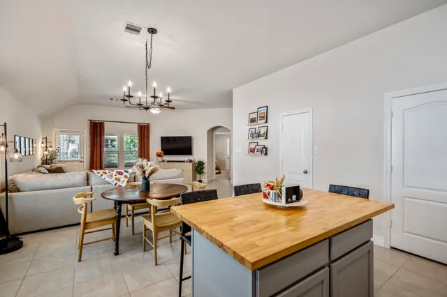a view of a dining room with furniture and chandelier