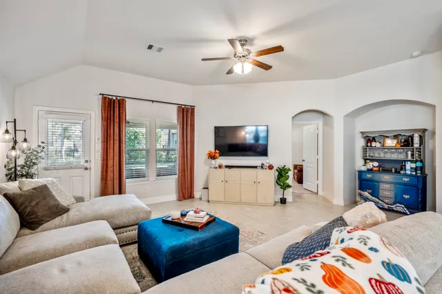 a bedroom with furniture and a flat screen tv