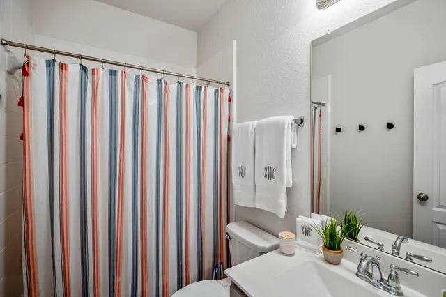 a view of a bathroom with a shower curtain