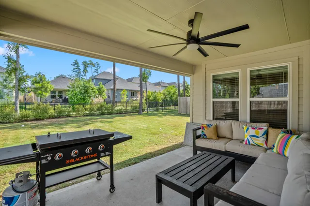 a sitting area with furniture and a yard