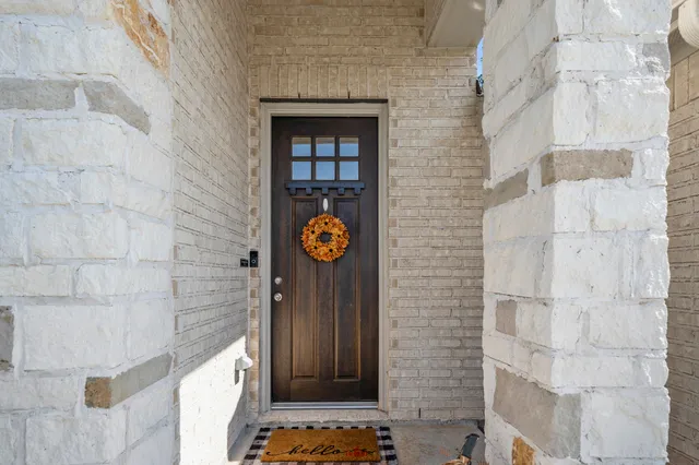a view of a door and brick wall