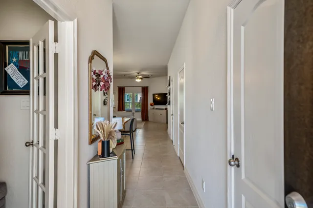 a view of a hallway with furniture and closet area