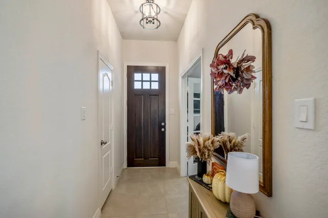 a view of a hallway with paintings on the wall