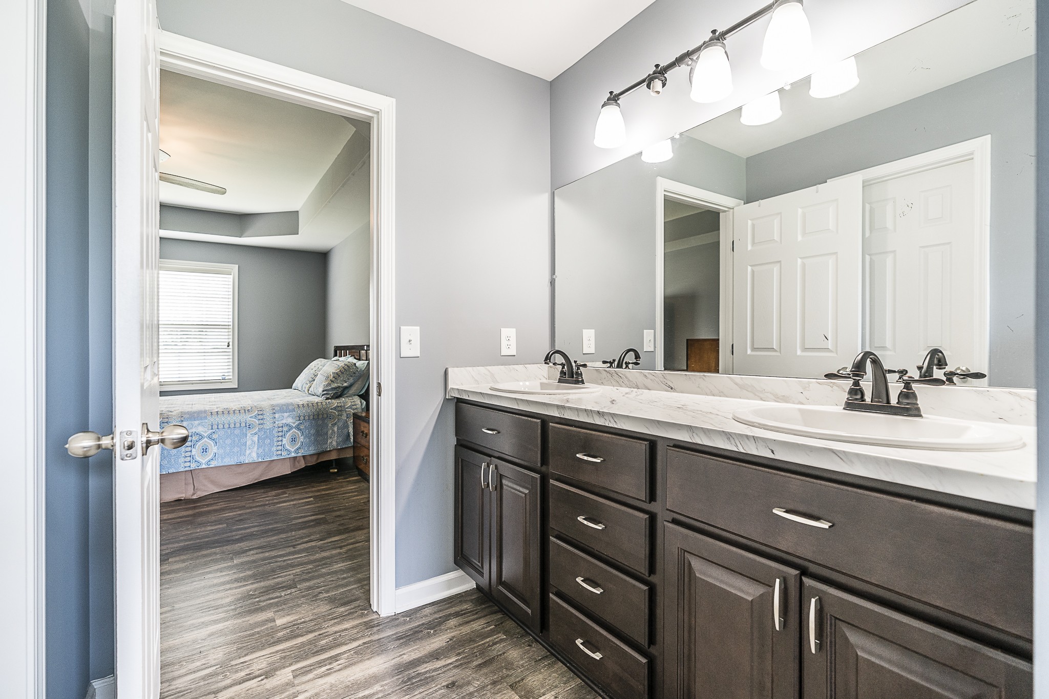 212 Scattersville Road Portland, TN 37148 - Photo 54 of 63 a en suite bathroom with a double vanity sink and a mirror