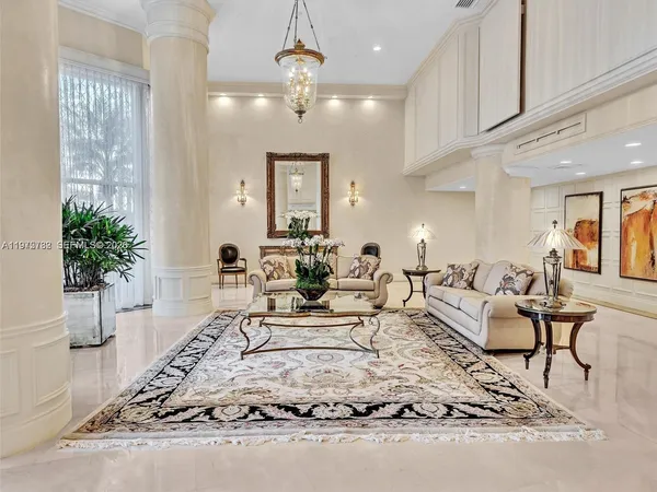 a living room with furniture and a chandelier