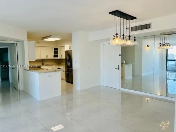 a large kitchen with cabinets and stainless steel appliances