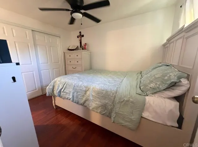 a bedroom with a bed and a mirror