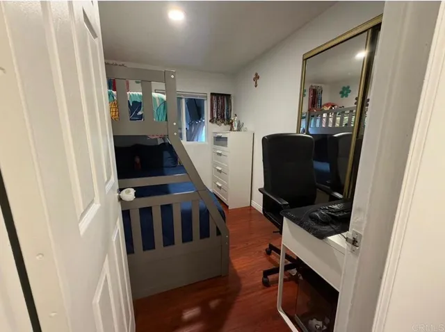 a view of a workspace with furniture and a gate