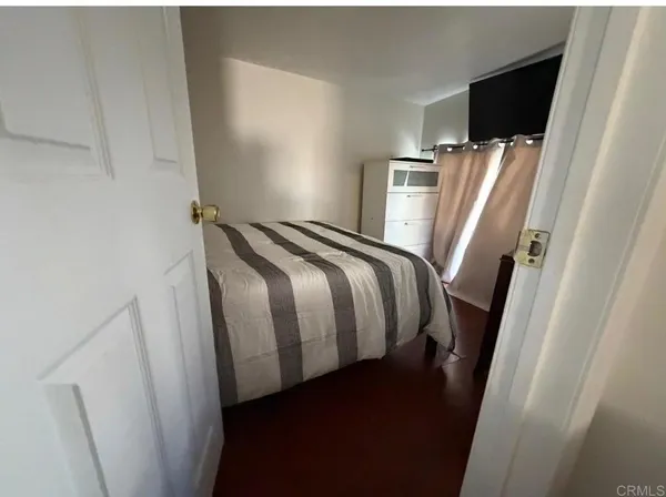 a view of walk in closet with an empty room