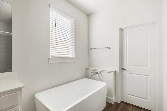 a white bath tub sitting next to a white sink