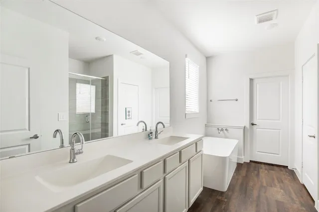 a bathroom with a double vanity sink and mirror