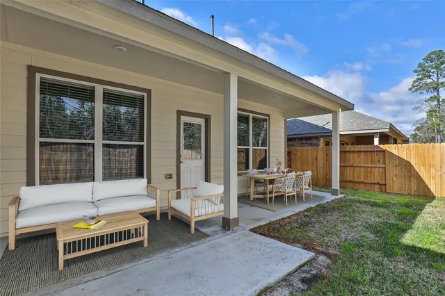 a backyard of a house with table and chairs