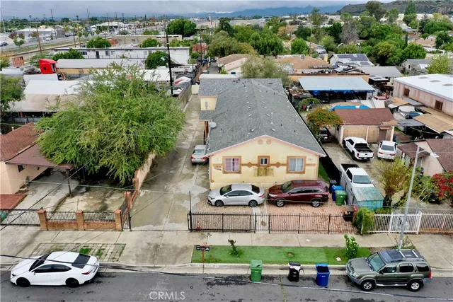 an aerial view of a houses with cars