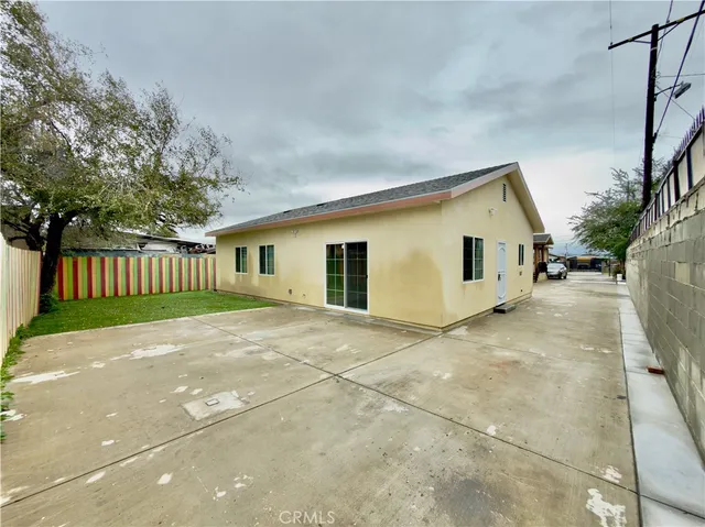 a view of a backyard with plants and a tree