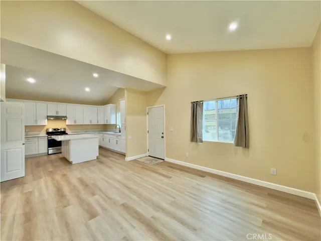 a view of a kitchen with a sink and a refrigerator