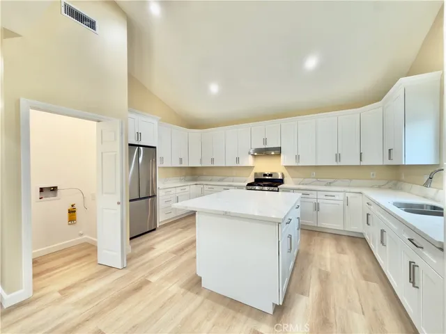 a kitchen with a sink stove and refrigerator