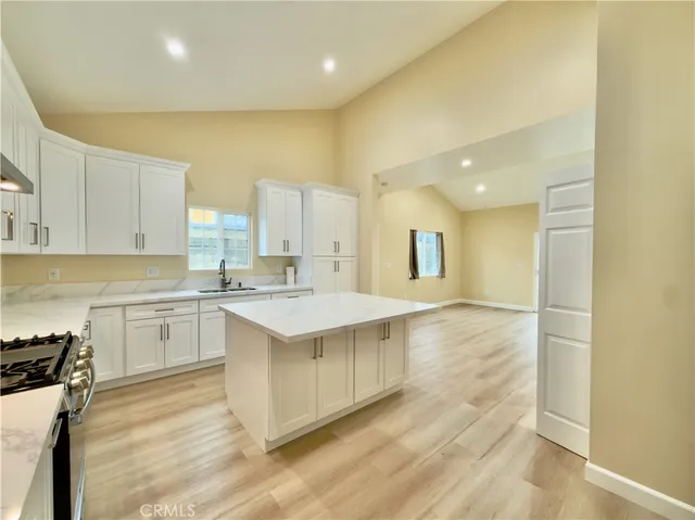 a kitchen with white cabinets appliances and sink
