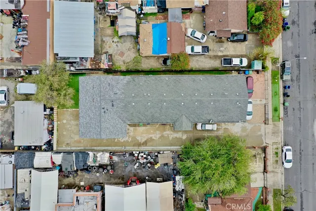 an aerial view of a house with a yard