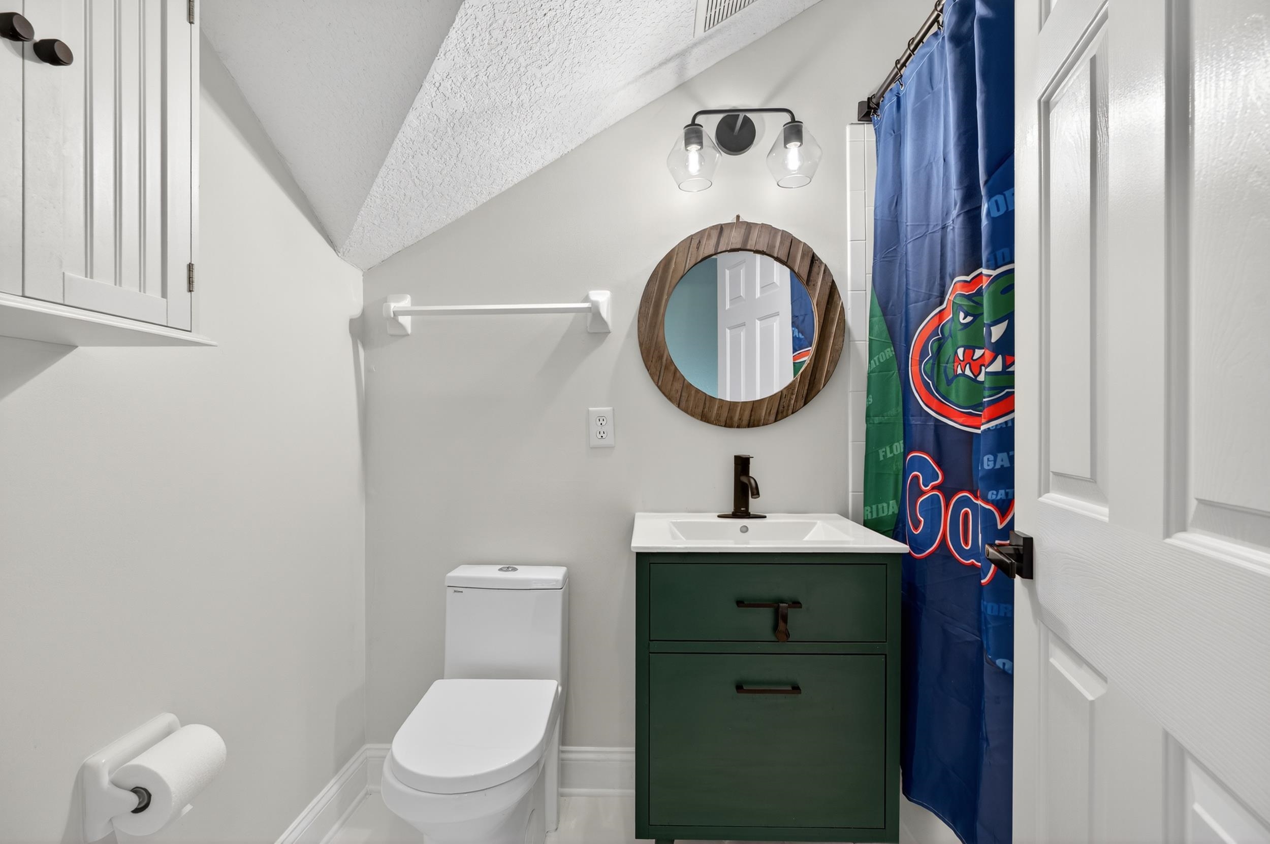 641 Pelham Road St. Augustine, FL 32092 - Photo 22 of 62 a bathroom with a toilet sink vanity and mirror