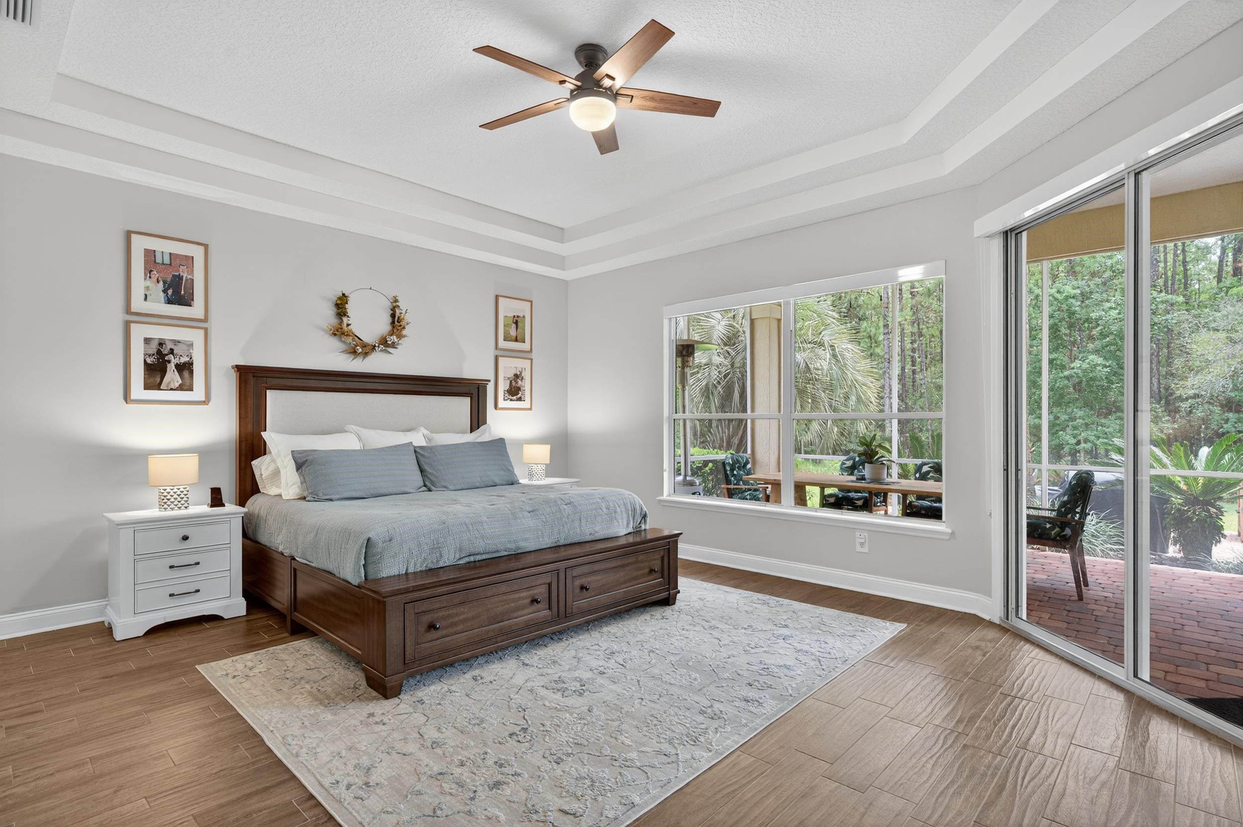641 Pelham Road St. Augustine, FL 32092 - Photo 23 of 62 a spacious bedroom with a large bed and a chandelier fan