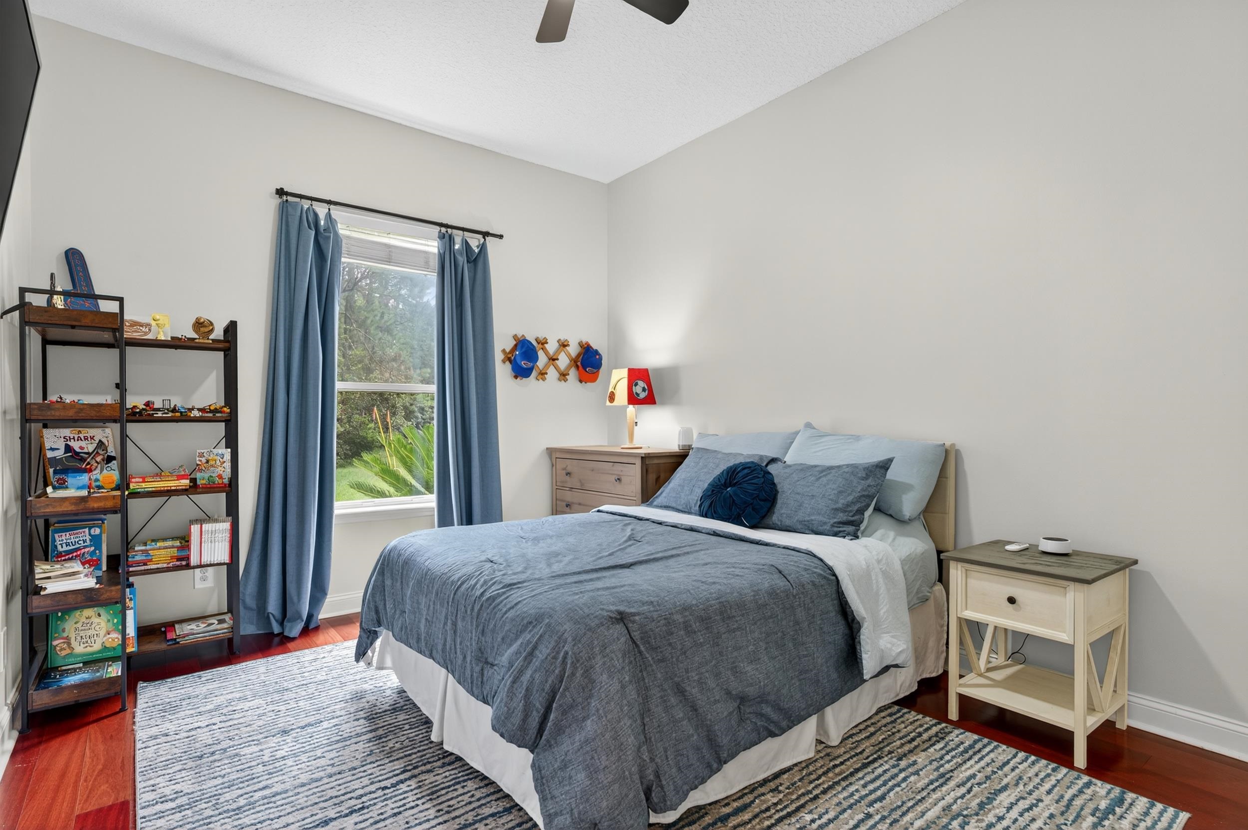 641 Pelham Road St. Augustine, FL 32092 - Photo 29 of 62 a bed sitting in a bedroom next to a book shelf