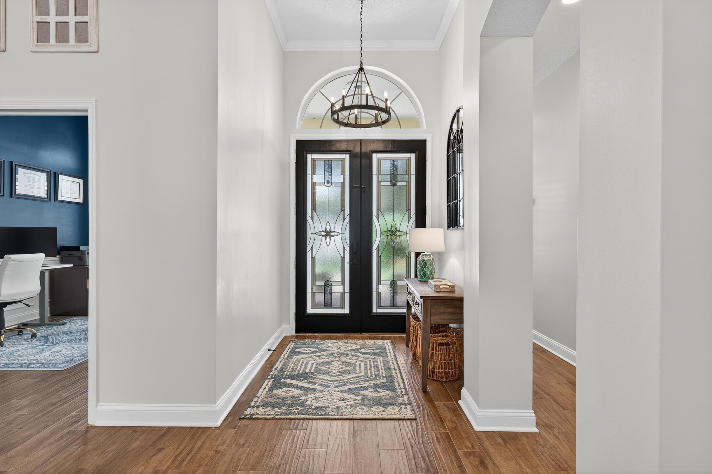641 Pelham Road St. Augustine, FL 32092 - Photo 4 of 62 a view of a hallway with wooden floor and windows