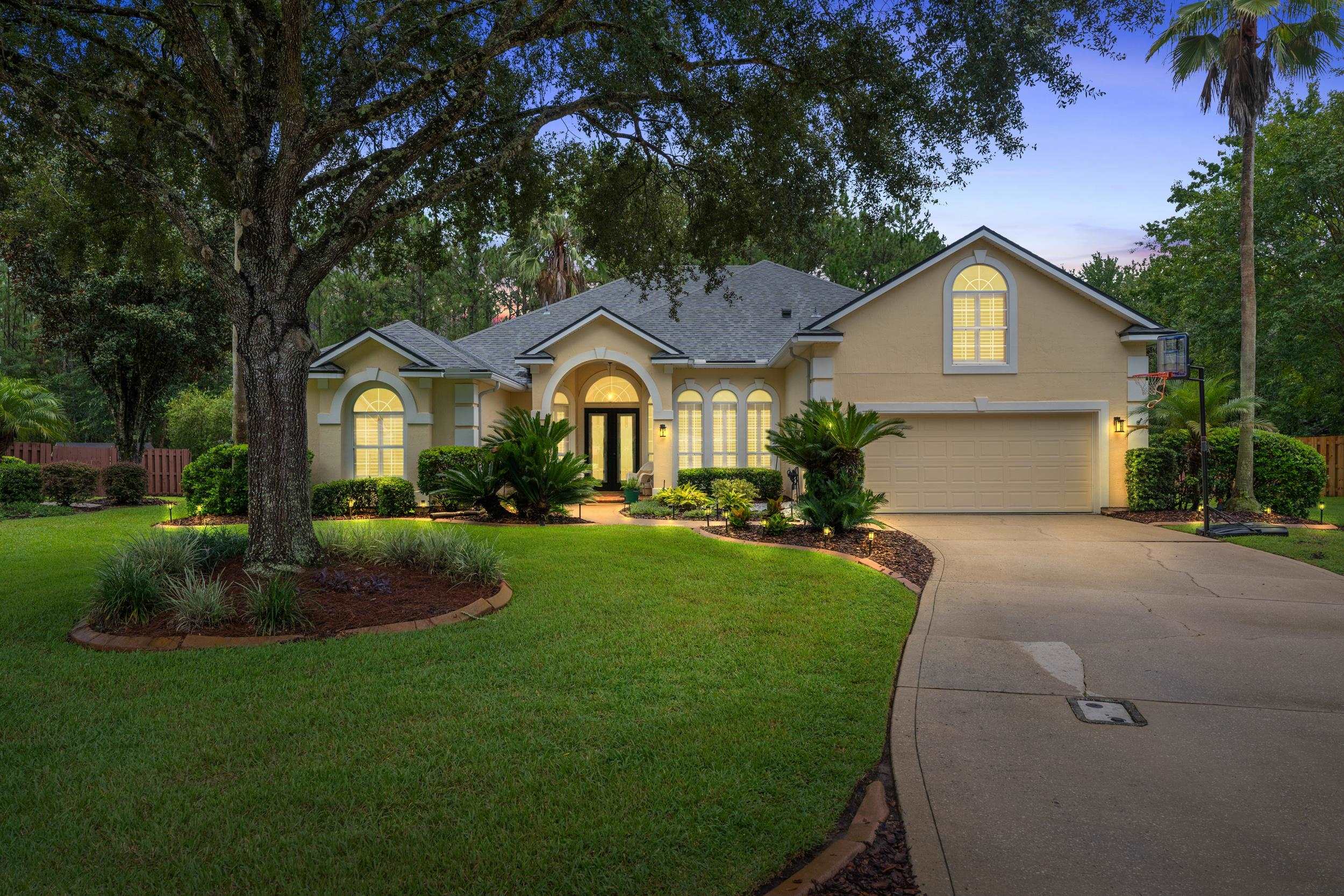 641 Pelham Road St. Augustine, FL 32092 - Photo 60 of 62 a front view of a house with a garden and trees