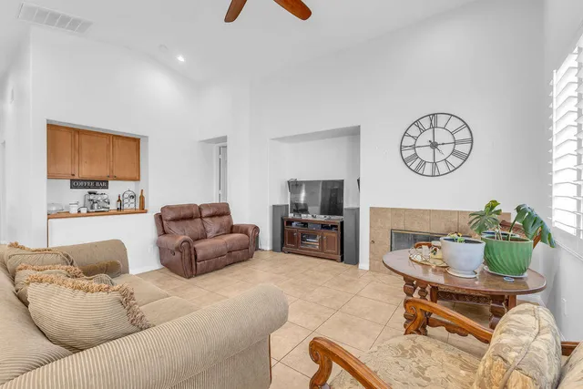 a living room with furniture a rug and a window