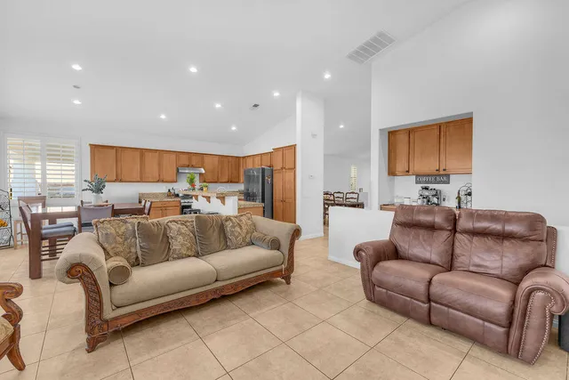 a living room with furniture kitchen view and a couch