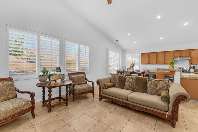 a living room with furniture and floor to ceiling window