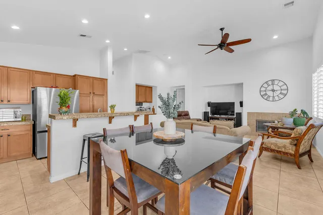 a kitchen with a table chairs refrigerator and microwave