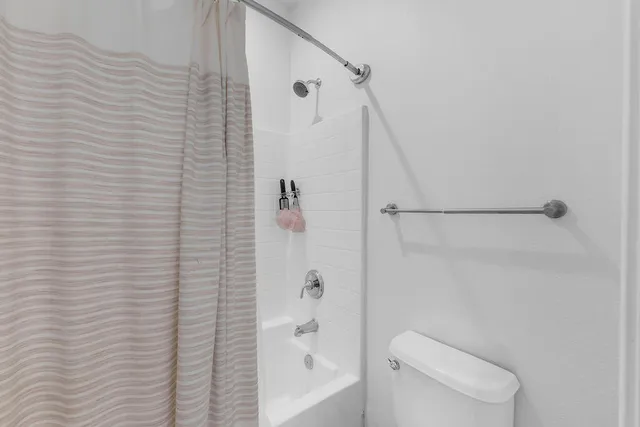 a bathroom with a shower and a toilet