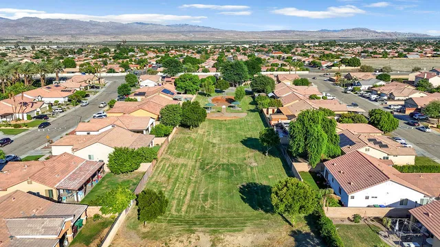 an aerial view of residential houses with outdoor space