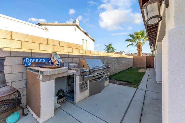 a view of a patio with table and chairs