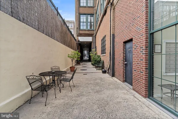 a view of a patio with table and chairs and potted plants