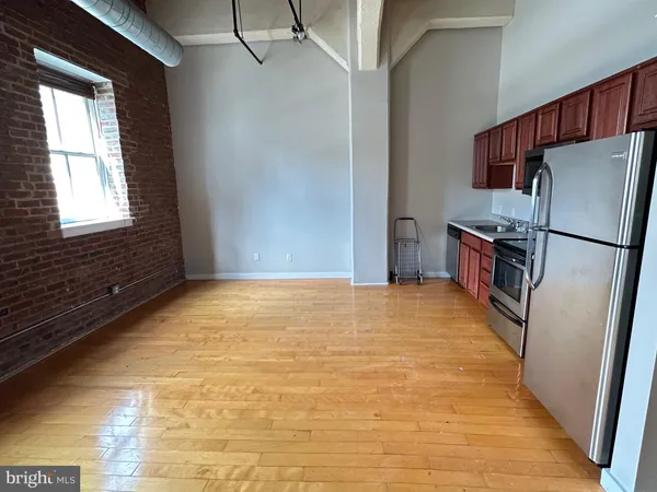 a view of a kitchen with a sink and a refrigerator